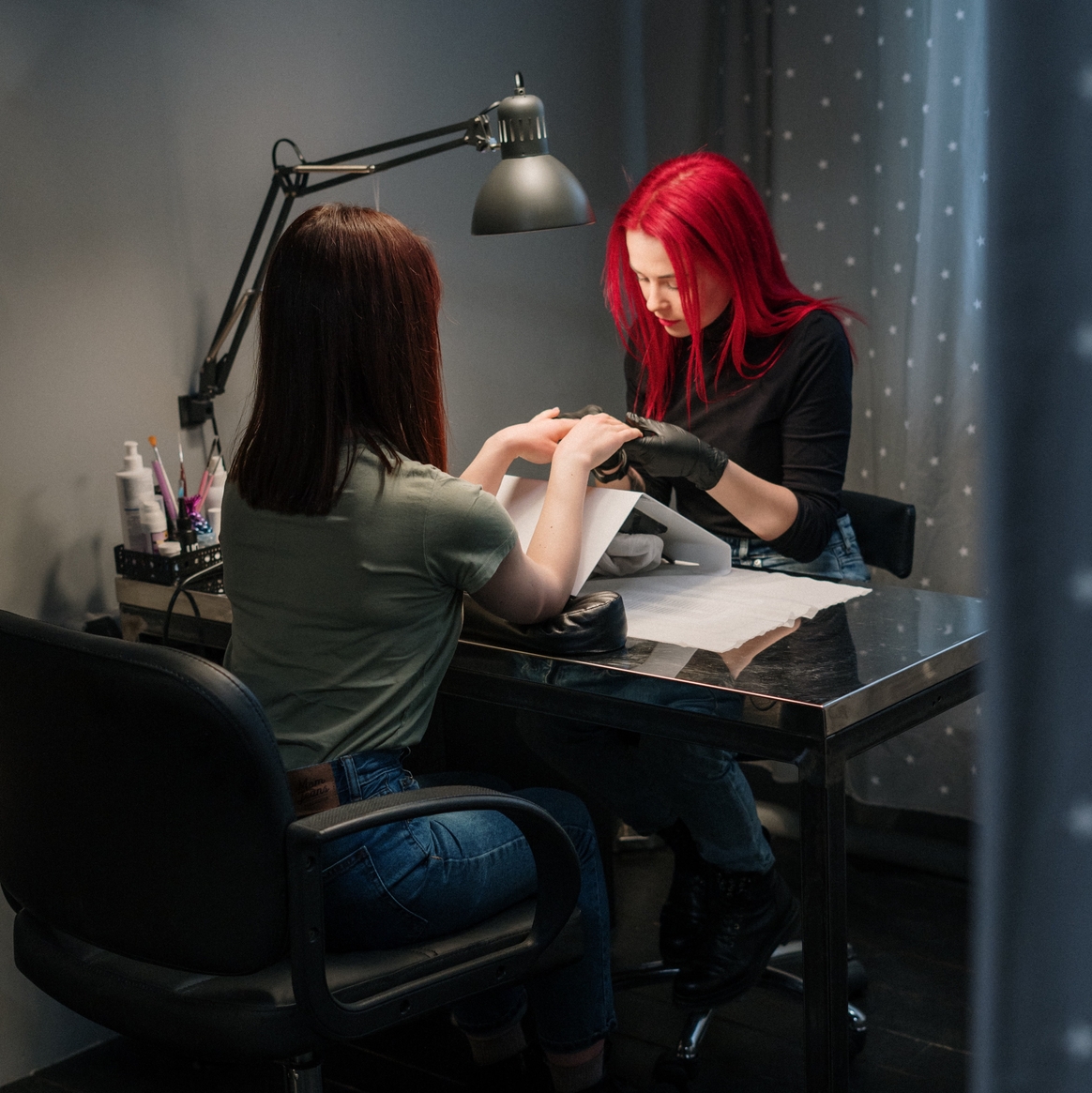 Client getting their nails done by the nail technician.